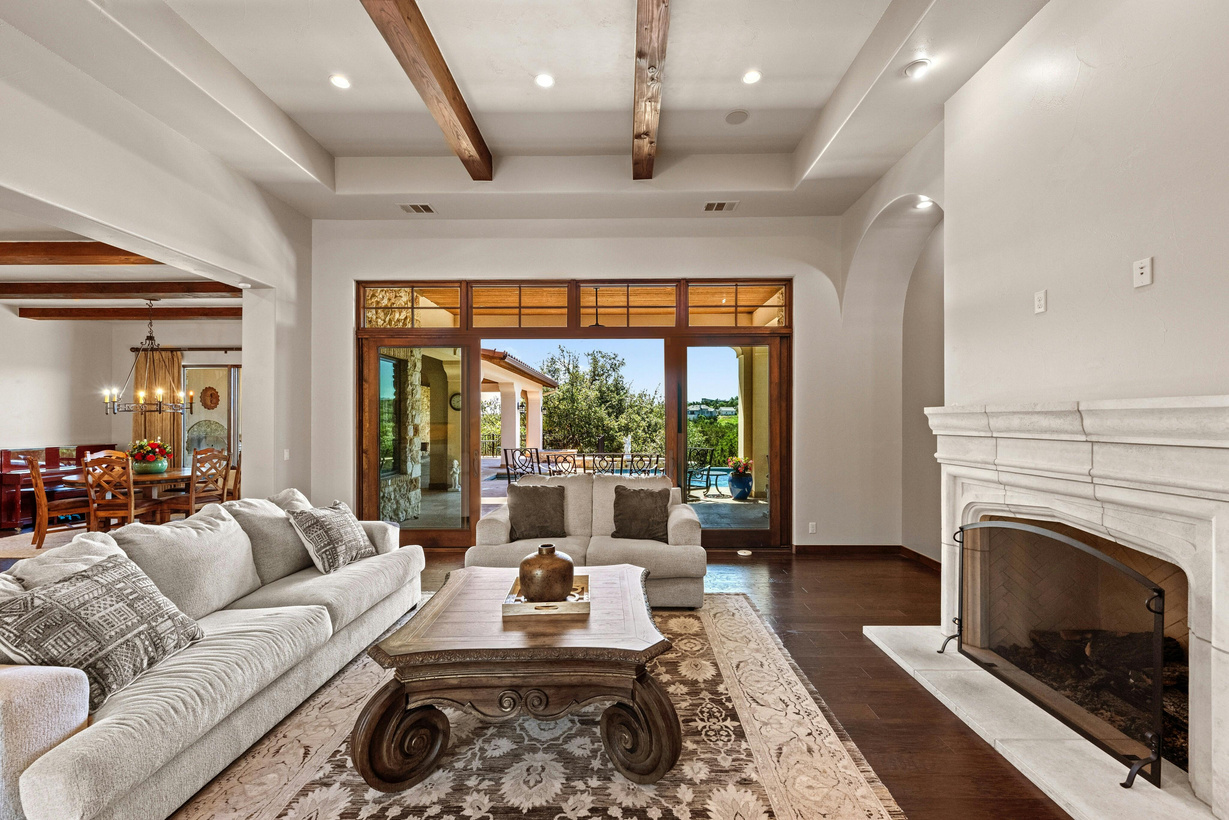 Interior living room with wood-beam ceiling and stone fireplace — listing photography example